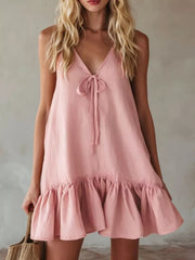 Pink tie-front mini dress with ruffle hem and V-neckline.