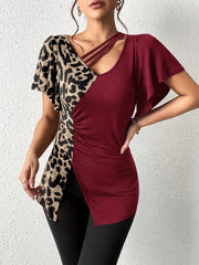 Asymmetric burgundy and leopard print blouse with cutout neckline and ruched side.