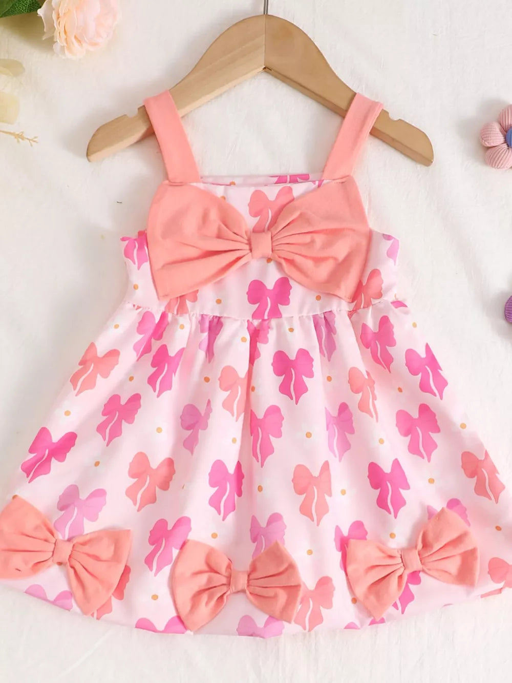 Pink cotton baby dress with bow print and bow details
