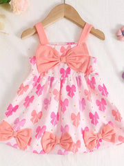 Pink cotton baby dress with bow print and bow details
