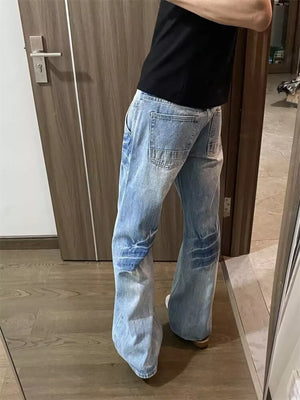 Men's light wash wide-leg jeans with vintage detailing and a relaxed fit.
