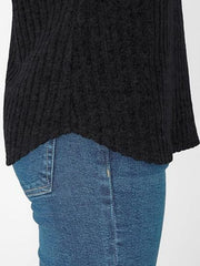 Black ribbed V-neck t-shirt with a relaxed fit and curved hem, worn with blue jeans.