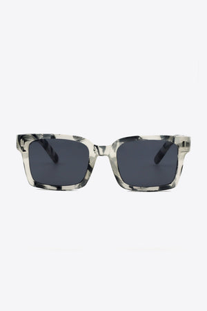 Marble effect rectangular sunglasses with dark lenses and bold frames.