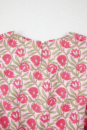 Dusty pink floral print crop top with a round neckline and button closure.
