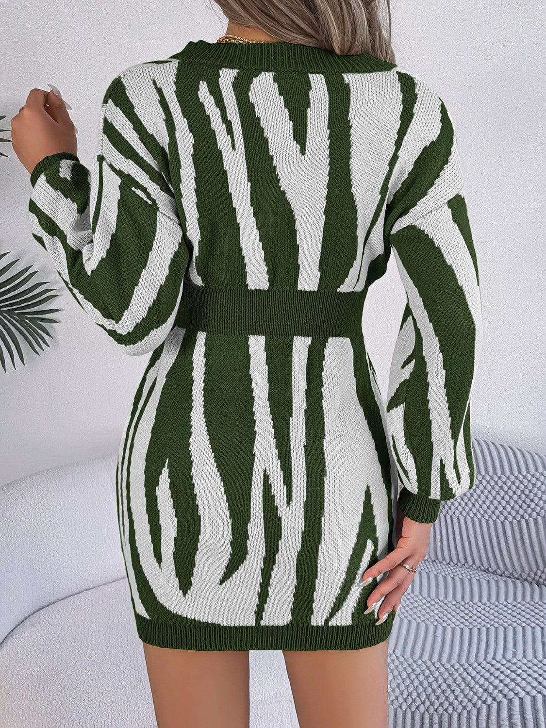 Zebra stripe knit fit-and-flare dress in army green with long sleeves and a cinched waist.