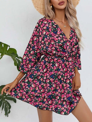 Black floral mini dress with v-neck, 3/4 sleeves, and ruffle hem.
