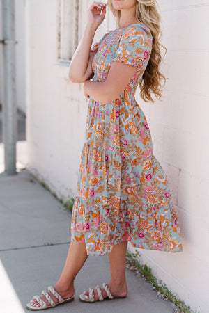 Floral smocked bodice tiered midi dress with short sleeves and a-line cut.