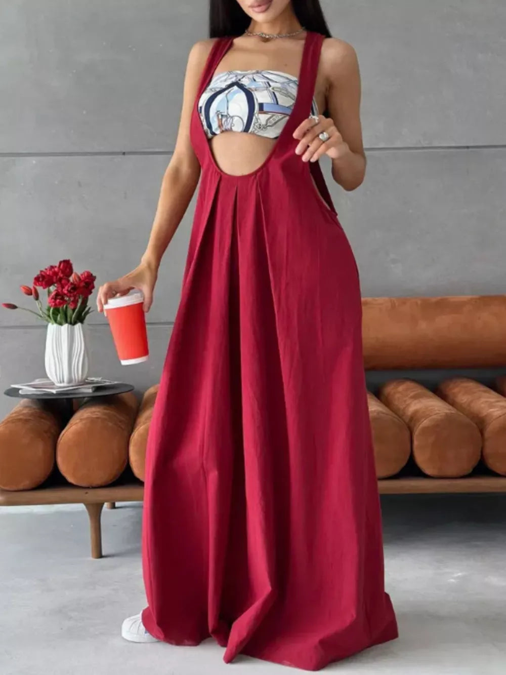 Wine Red pleated overall dress with wide legs and a scoop neckline.