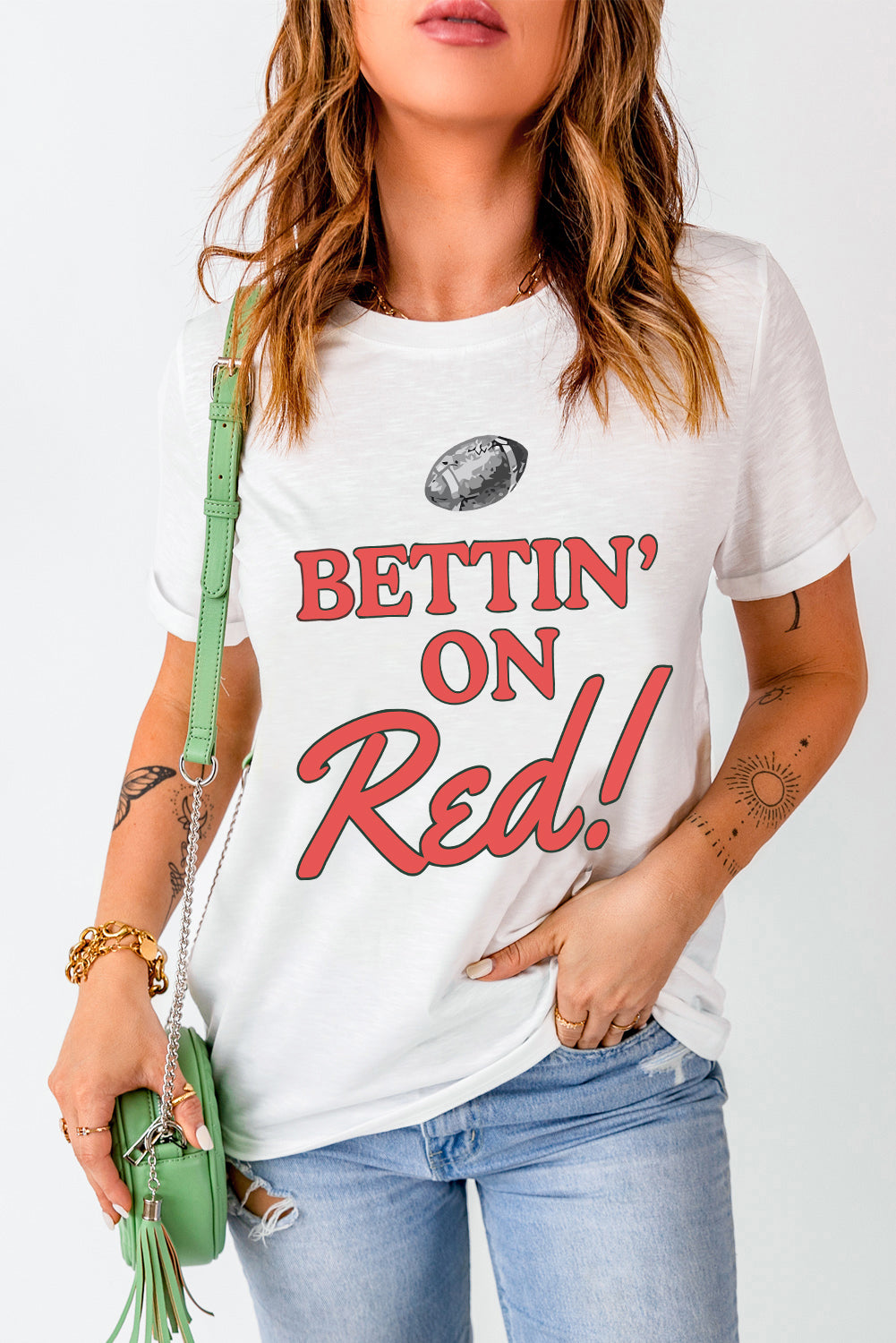White graphic t-shirt with red text saying Bettin' On Red! and a football graphic.