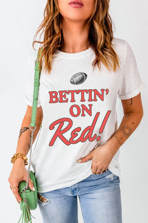 White graphic t-shirt with red text saying Bettin' On Red! and a football graphic.