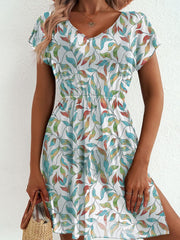 Vibrant leaf print mini dress with slit and V-neck, short sleeves, and elastic waist.
