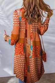 Patchwork print duster shirt jacket in orange with paisley and geometric patterns, long sleeves, button front.