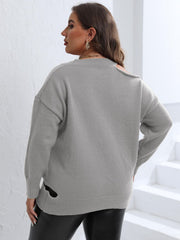 Light gray knit sweater with asymmetric shoulder detail and side slits.