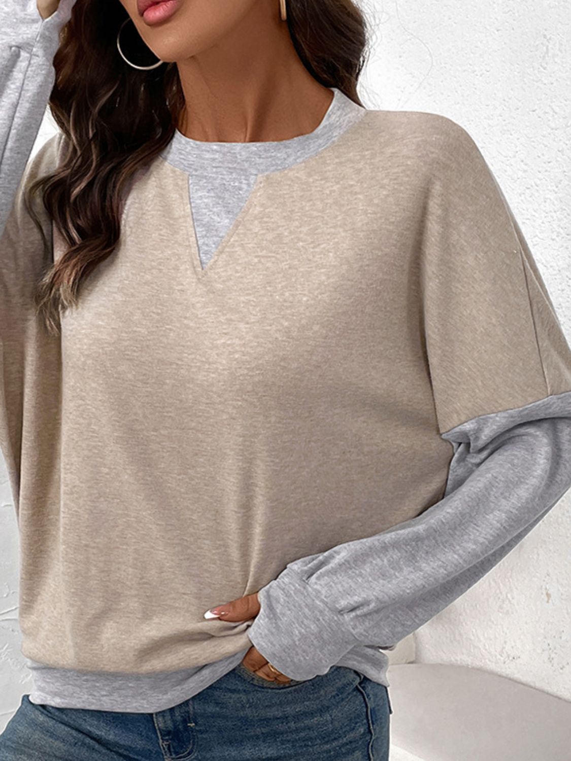 Layered tan and grey v-neck sweatshirt with long sleeves and a casual fit.