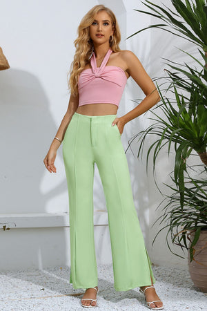 Neon green tailored trousers with split hems and a comfortable, casual fit.