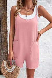 Blush pink relaxed romper with patch pockets and a white layered tank top.