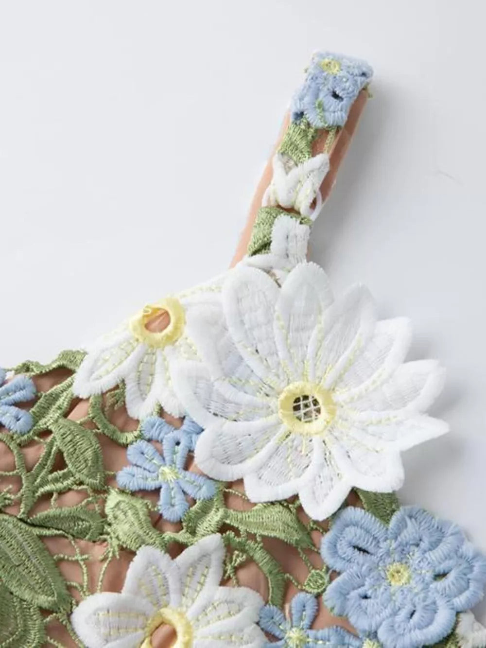Maxi dress with embroidered floral appliqué detail on straps and bodice in white and blue.