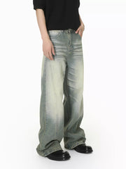 Men's light wash wide leg jeans with a relaxed fit and distressed details.