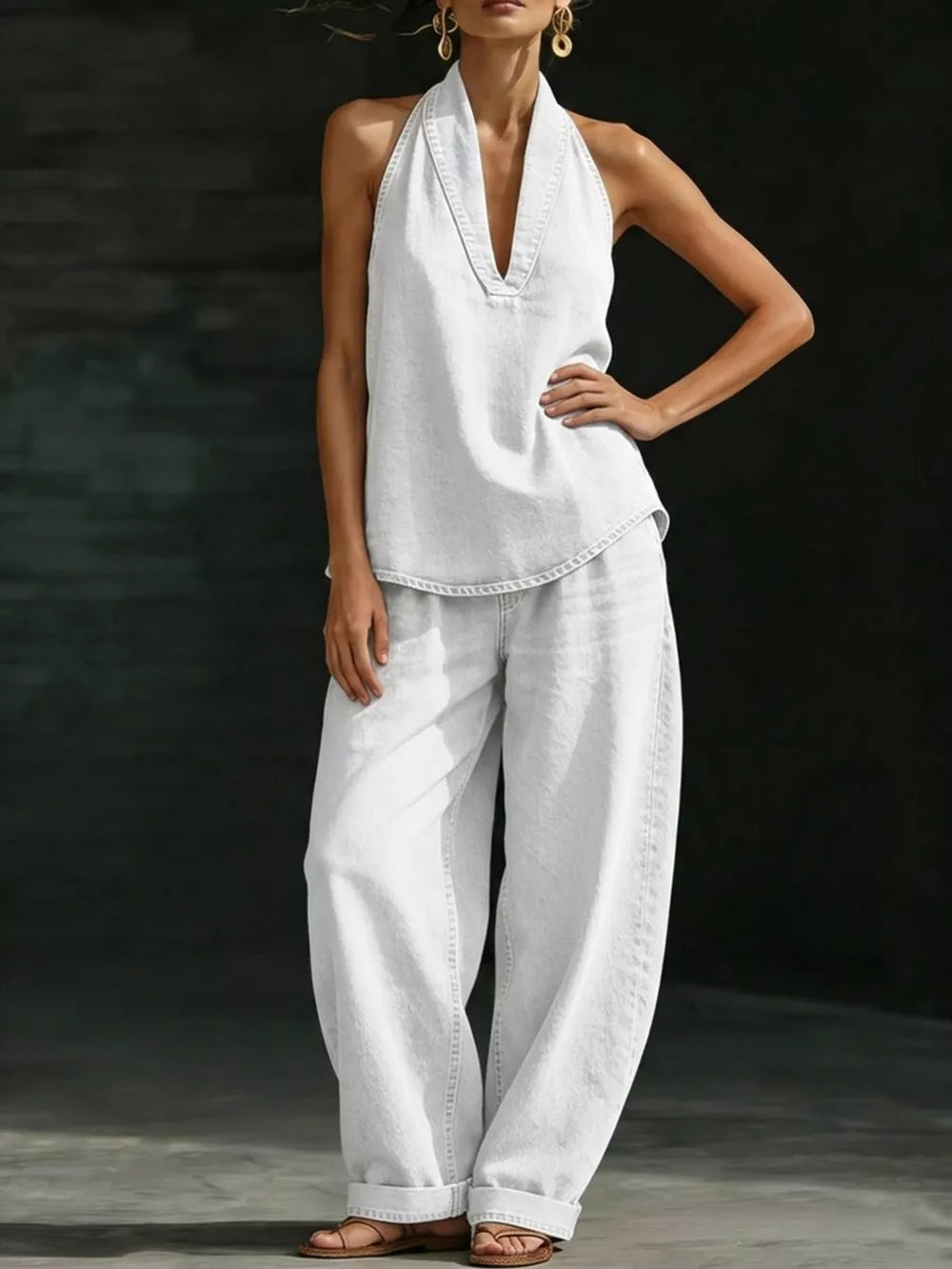 White halter neck top with deep V-neck and wide-leg pants ensemble.