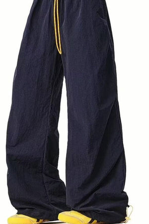 Men's navy loose-fit drawstring sweatpants with a relaxed cut and yellow drawstring detail.