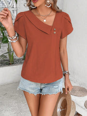 Asymmetric collar top in rust orange with button detail and short sleeves.