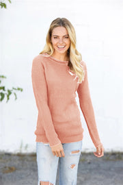 Textured raglan pullover sweater in watermelon pink acrylic with honeycomb knit pattern.