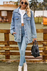 Oversized denim trucker jacket in medium wash with classic button front and chest pockets.