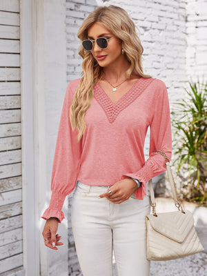 Coral lace trim V-neck blouse with blouson sleeves and smocked cuffs.