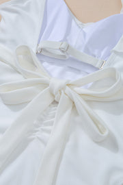 White textured wrap swimsuit with tie back detail and adjustable straps.