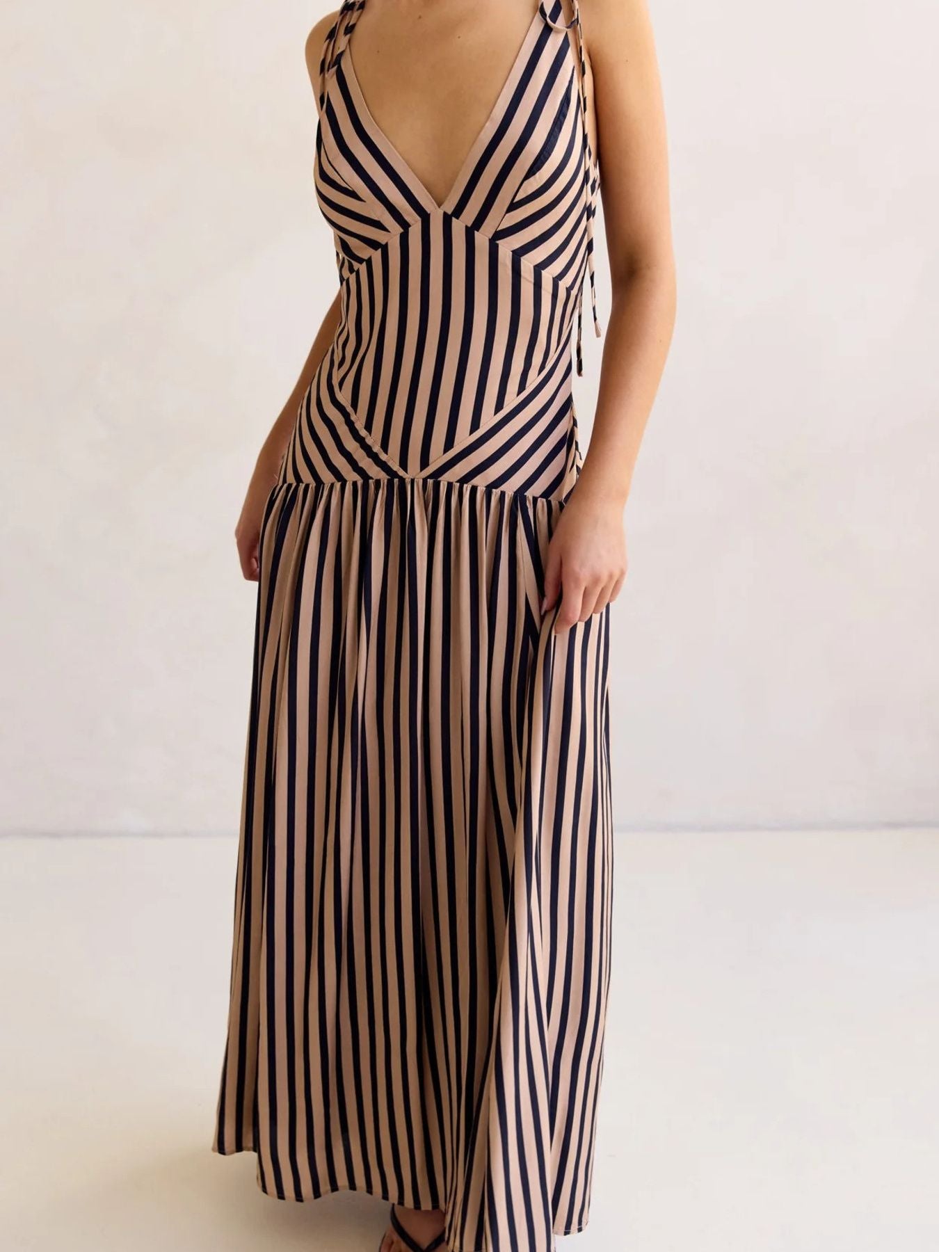 Tie-shoulder maxi dress with V-neck in brown and navy stripes, featuring adjustable straps.
