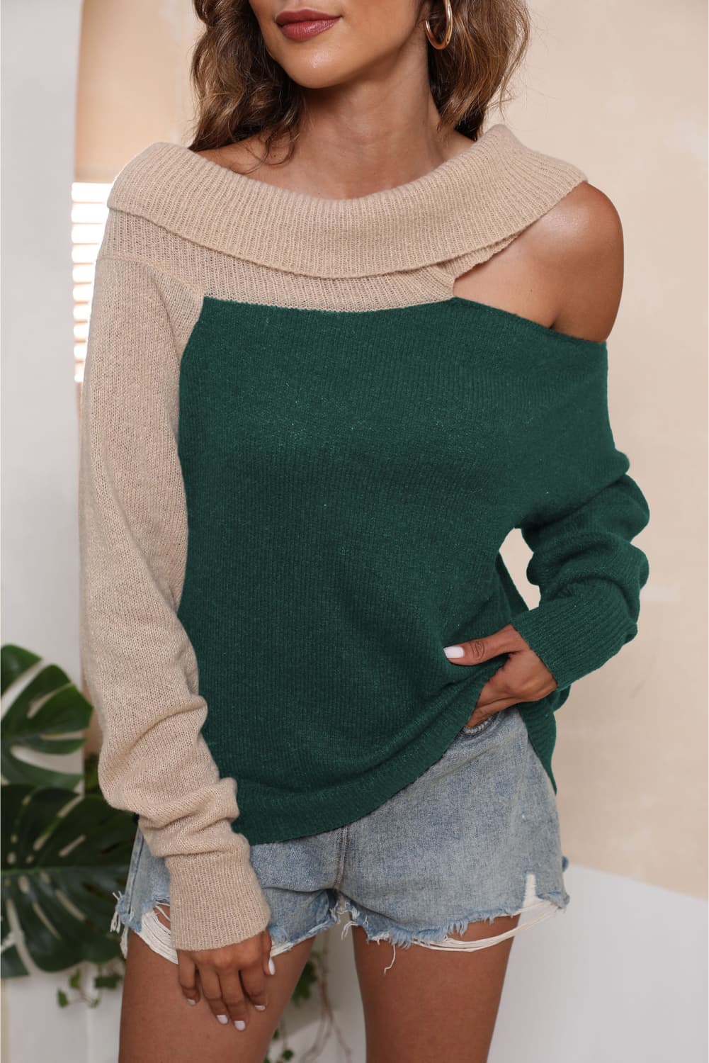 Asymmetric shoulder sweater in dark green and beige acrylic with boat neck.