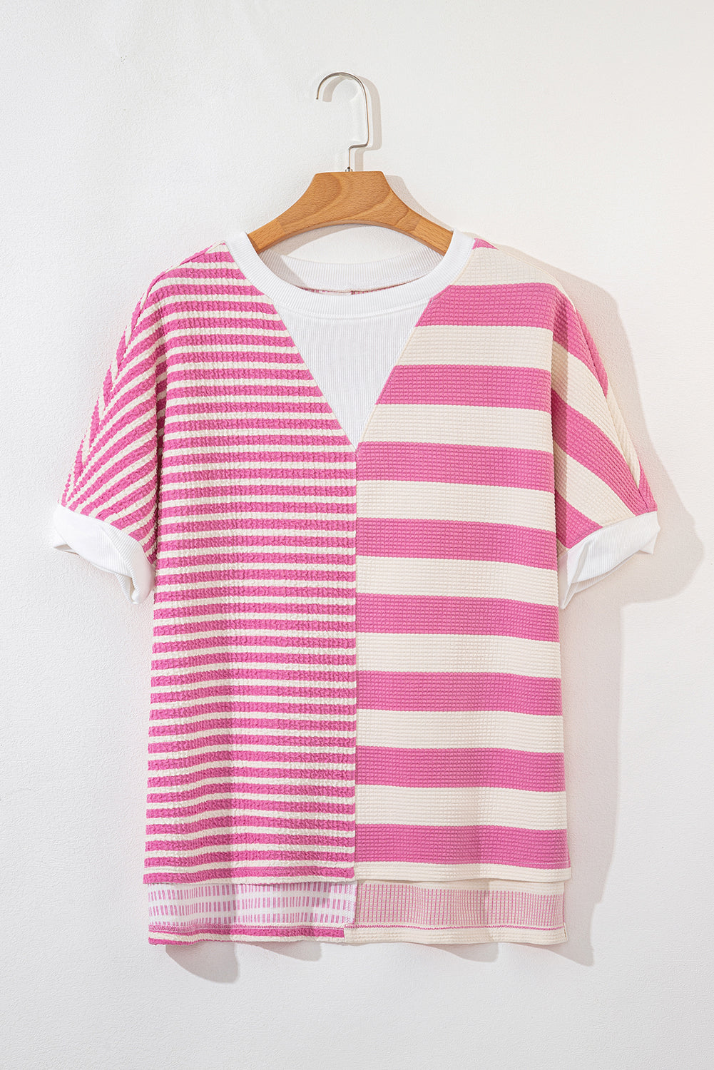 Pink and cream striped waffle knit top with a V-neck detail and short sleeves.