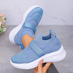 Blue mesh slip-on sneakers with adjustable straps adorned with rhinestones.