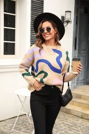 Tan abstract swirl knit crewneck sweater with blue, green, and pink accents.