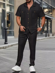 Men's black short-sleeve button-up shirt and drawstring pants set with subtle pattern
