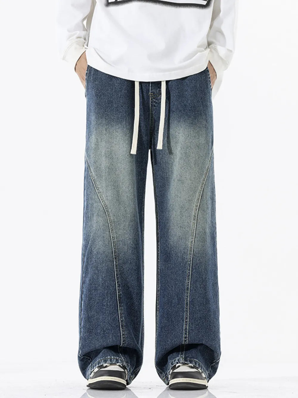 Relaxed fit wide-leg jeans in dark wash denim with drawstring waist and panel detail.