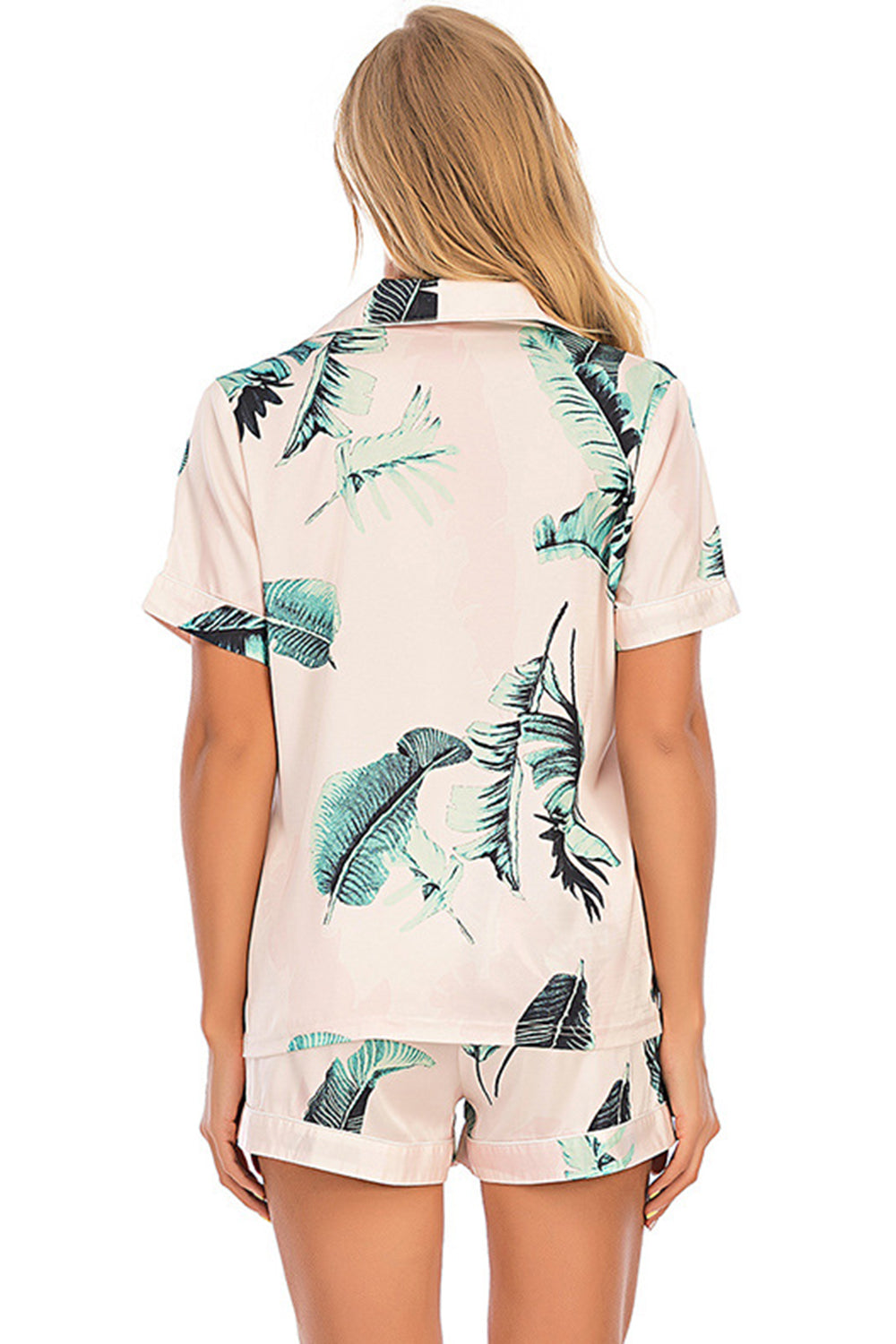 Botanical print satin pajama set in blush pink with short sleeves and shorts.