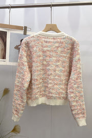 Textured bouclé knit cardigan in pastel multi-color with cream trim and cuffs.