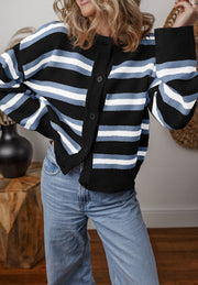 Black and pink striped knit cardigan with button front and crew neck.