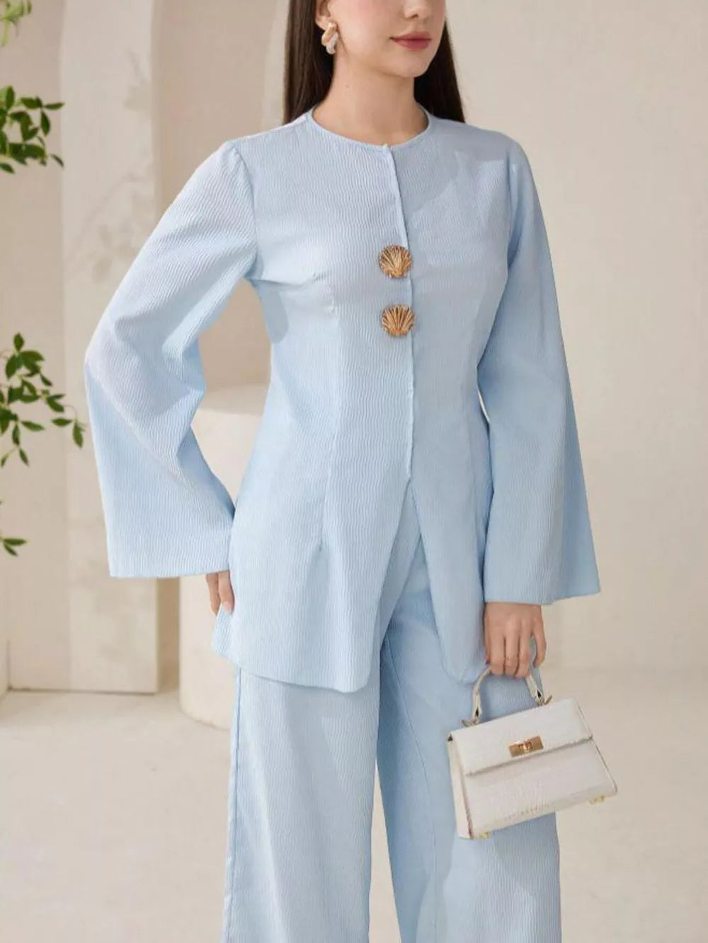Light blue crinkled texture two-piece set with shell buttons and wide-leg pants.