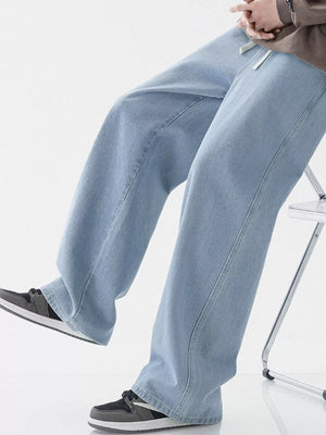 Light blue relaxed wide-leg jeans with drawstring detail.