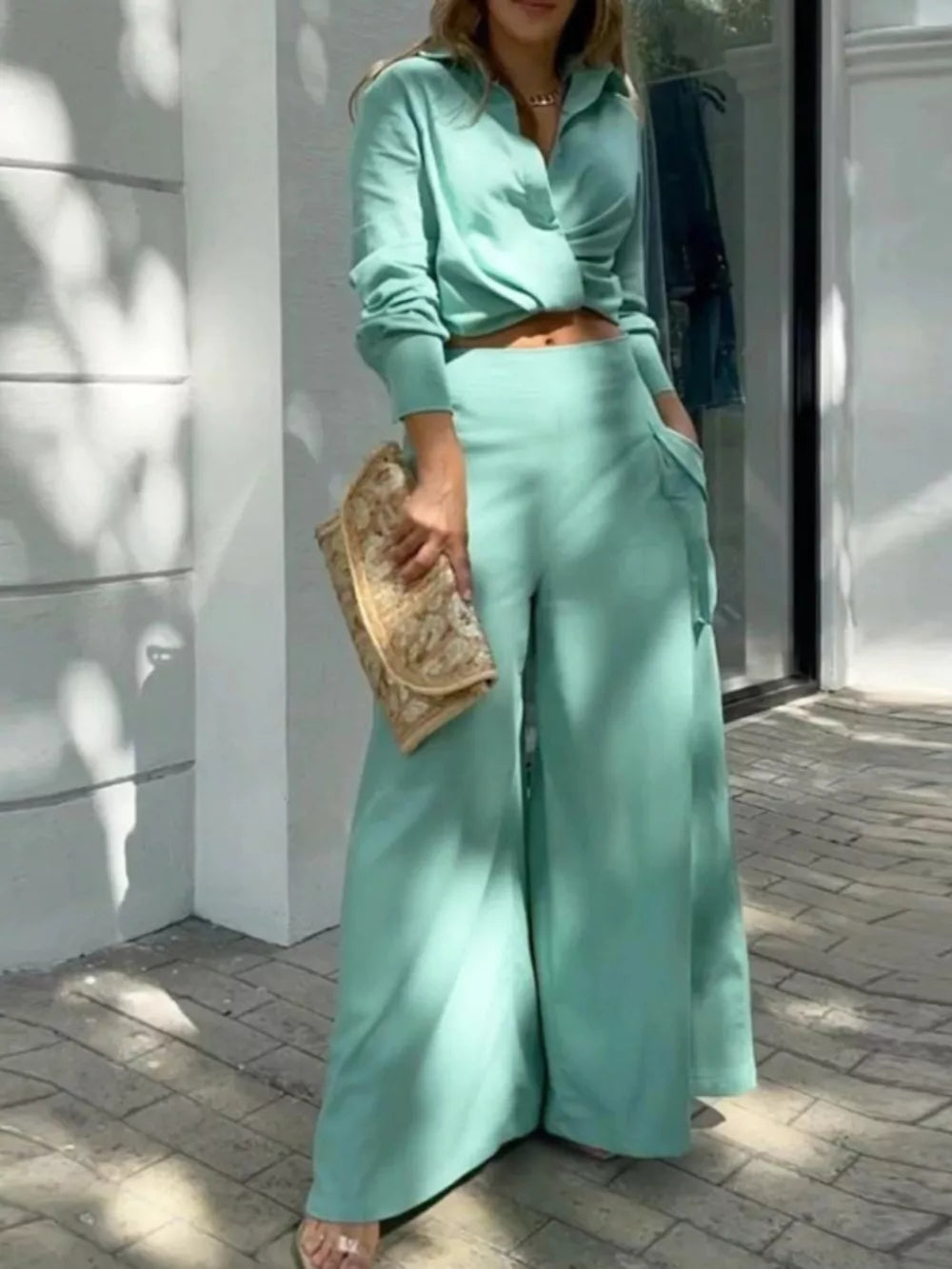 Teal two-piece set with pocketed wide-leg pants and a cropped collared shirt.