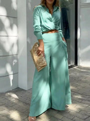 Teal two-piece set with pocketed wide-leg pants and a cropped collared shirt.