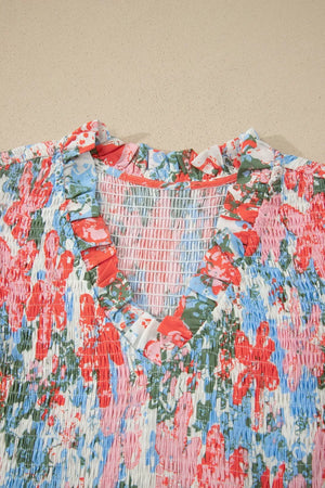 Vibrant floral maxi dress with smocked bodice, V-neck, and ruffled trim.