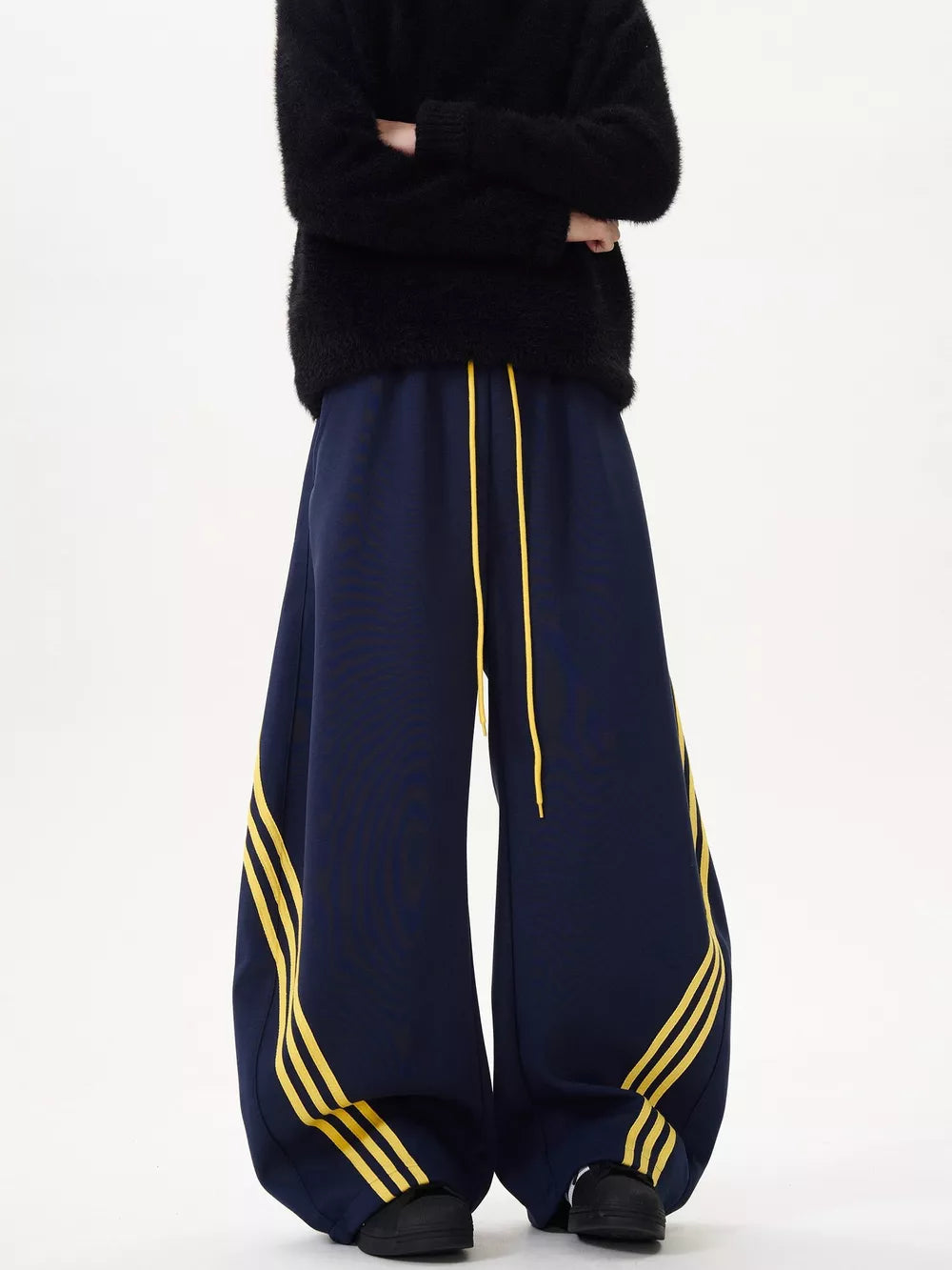 Navy wide-leg sweatpants with yellow stripes and drawstring waist.