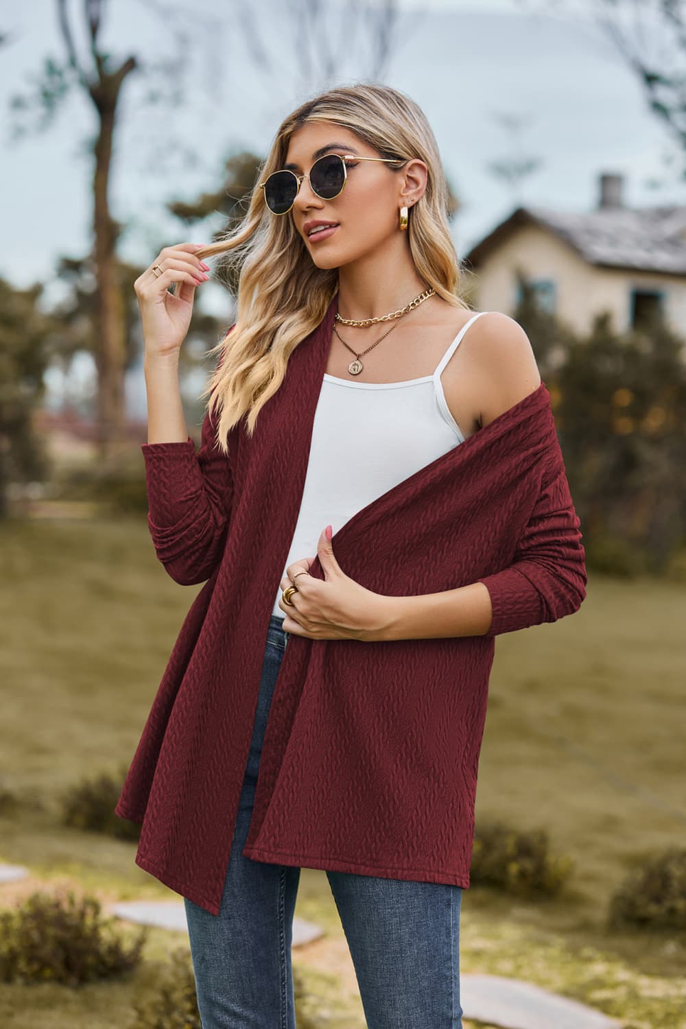 Burgundy textured knit cardigan with a drape-front and long sleeves.