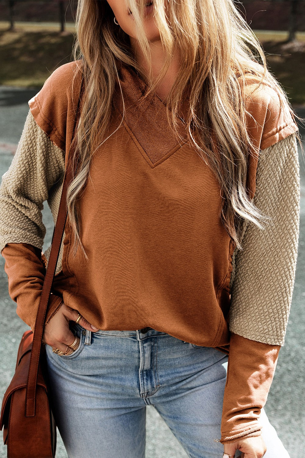 Caramel hoodie with textured tan sleeves and V-neck detail