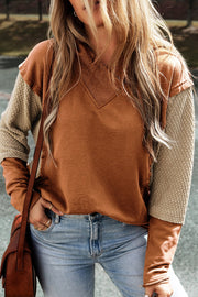 Caramel hoodie with textured tan sleeves and V-neck detail