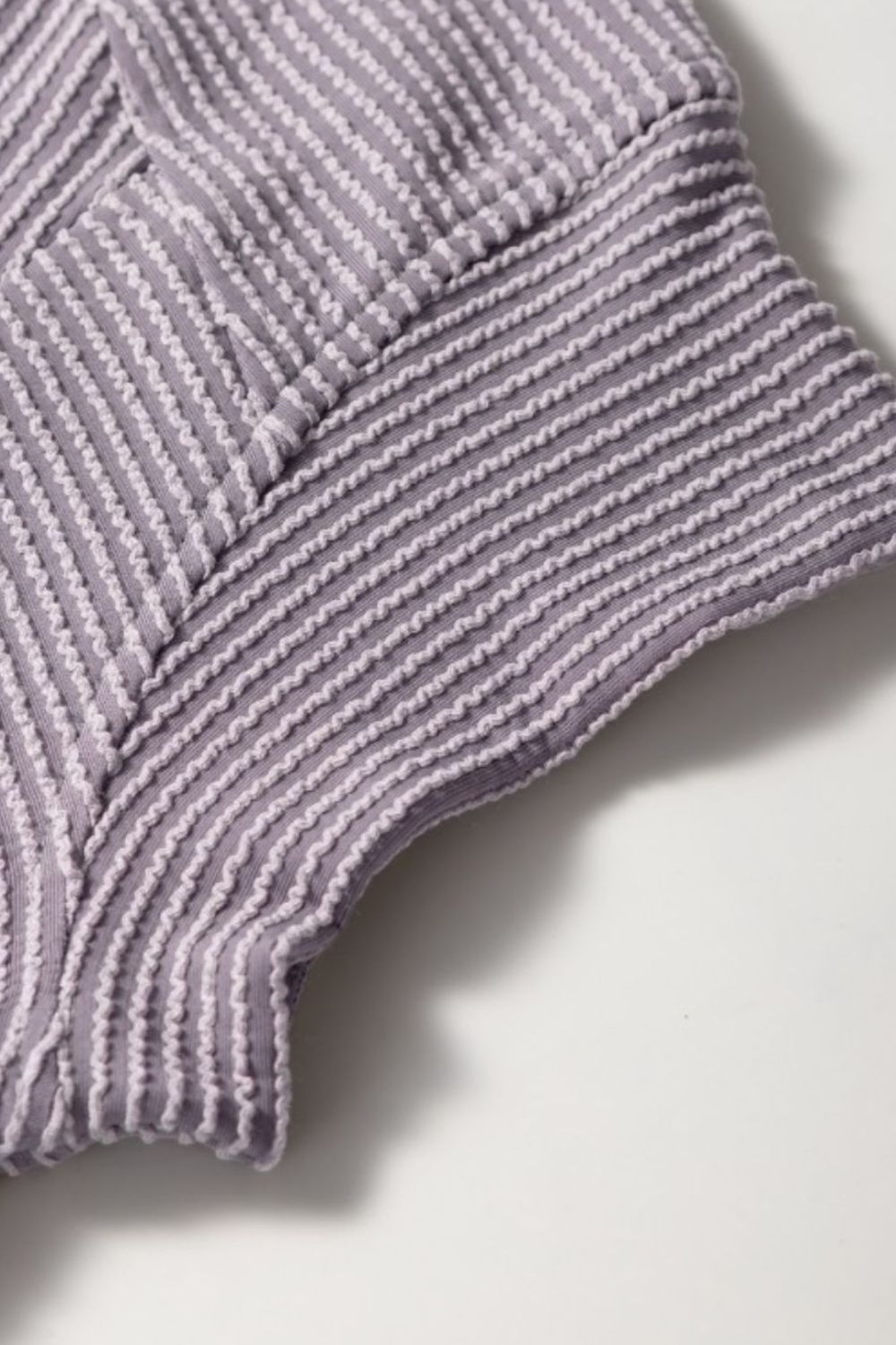 Gray ribbed knit drawstring co-ord set detail showing textured fabric and stitching.