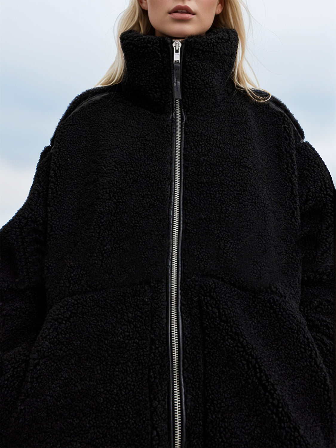 Black teddy fleece zip-up jacket with contrast piping and high neck.